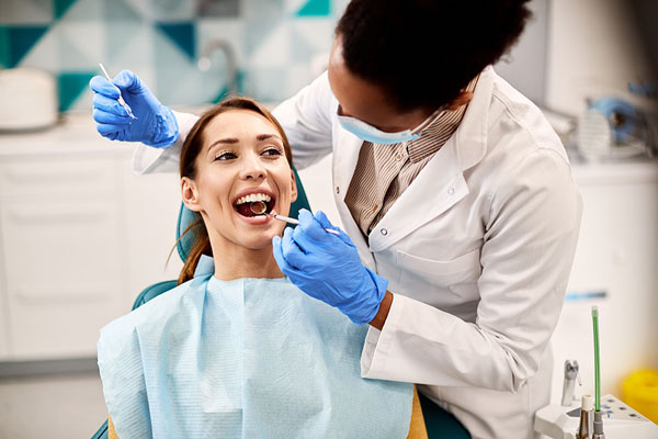 woman receiving an oral cancer screening