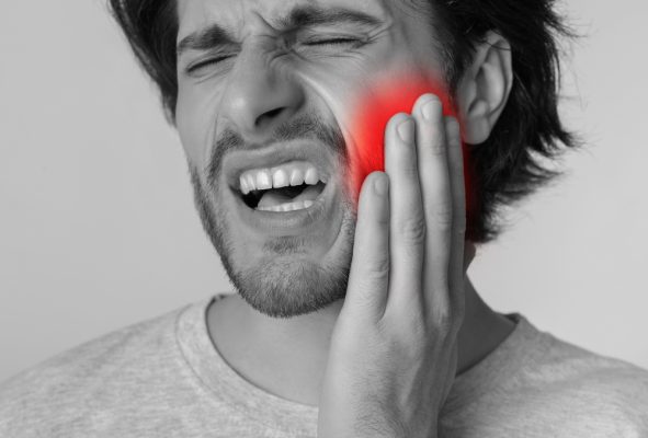 man dealing with tooth pain